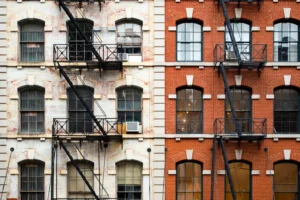 Close-up view of New York City style apartment buildings with emergency stairs along Mott Street in Chinatown neighborhood of Manhattan, New York, United States.